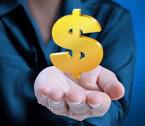 Man's hand holding Golden dollar simbol